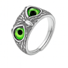 Silver ring with green gemstones on a white background