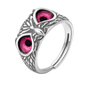 Silver ring with pink gemstones on a white background