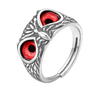 Silver ring with red gemstones on a white background